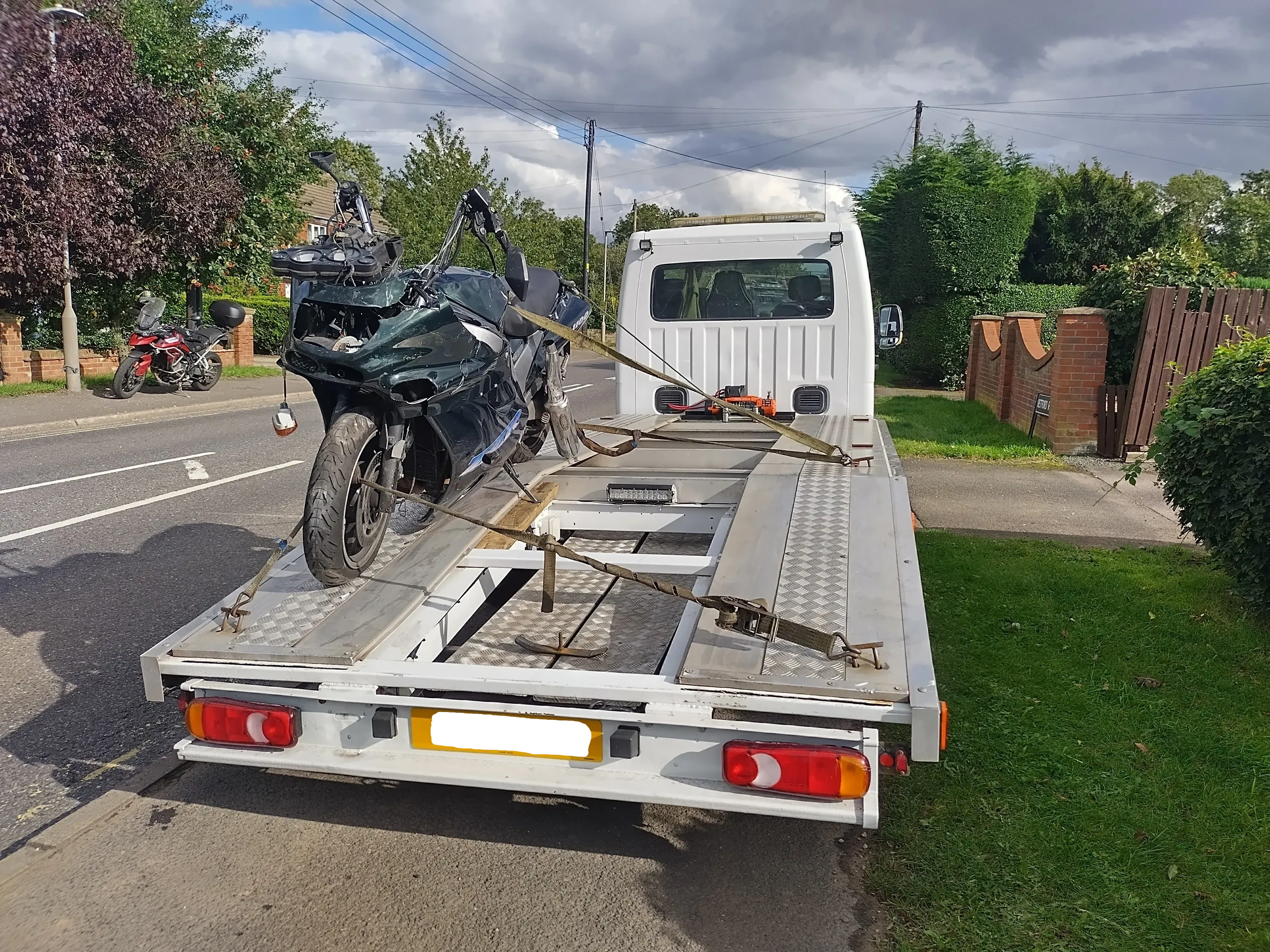 Motorbike recovery on flatbed truck